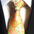 Pomarańczowy krawat w zielone wzory