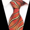 Pomarańczowy krawat w beżowe zakrzywione paski