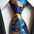 Niebiesko-pomarańczowy krawat w kwiaty